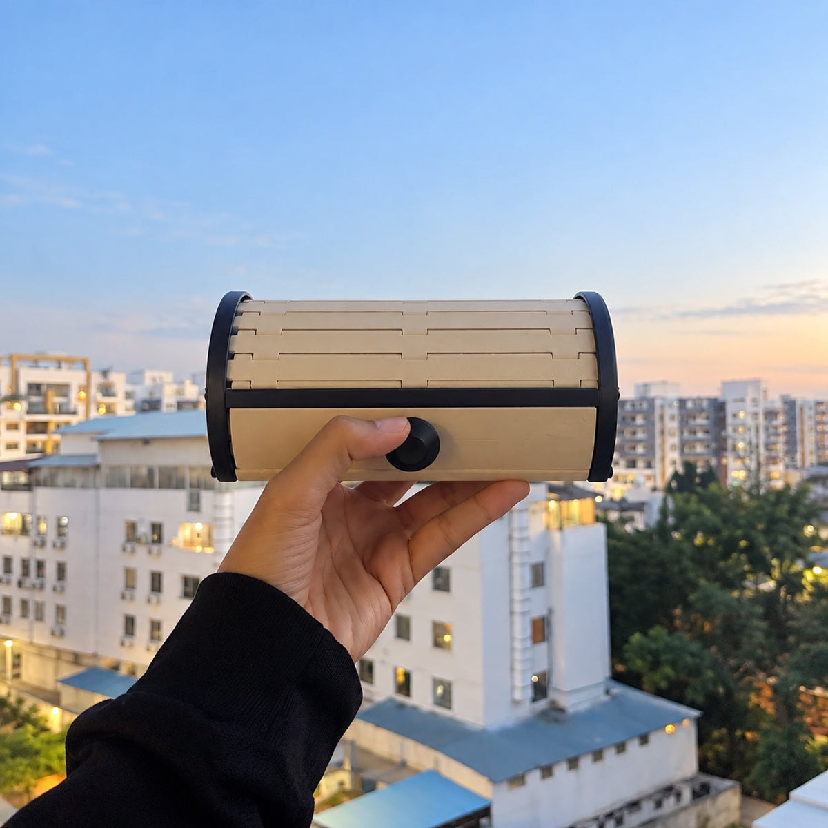 Tambour Vault Storage Box held against a city skyline