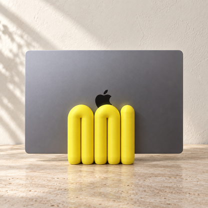 Yellow The Loop Stand holding a closed grey laptop, front view