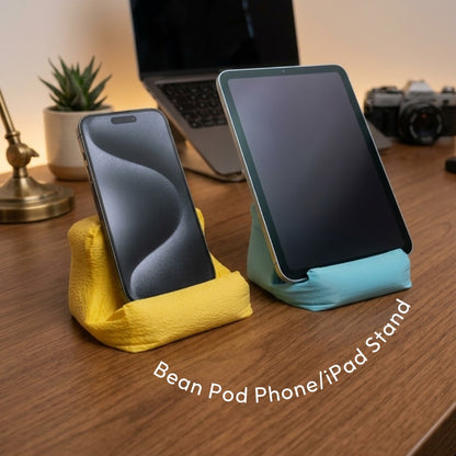Cushion Bean Pod holding a phone and a tablet on a desk