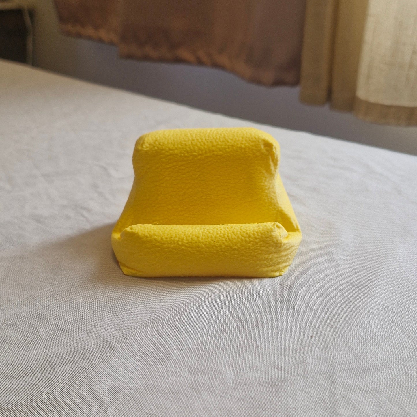 Cushion Bean Pod phone stand in yellow