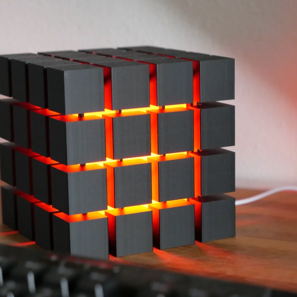 Rubrik Lamp — Black lamp with red diffuser glow