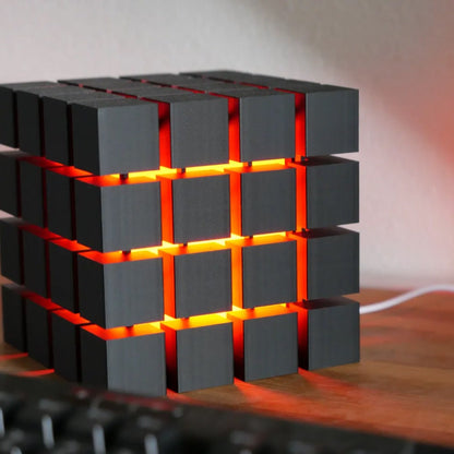Rubrik Lamp — Black lamp with red diffuser glow