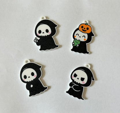 Four ghost keychain designs on white