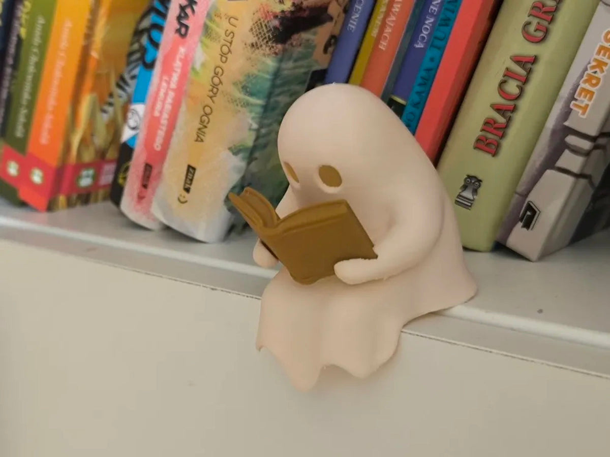 Studious Ghost - a ghost tealight reading a tiny book, glowing eyes on the page (secondary)