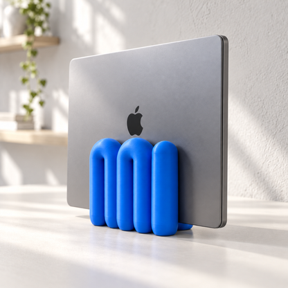 The Loop Stand in blue holding a closed grey laptop, right side view