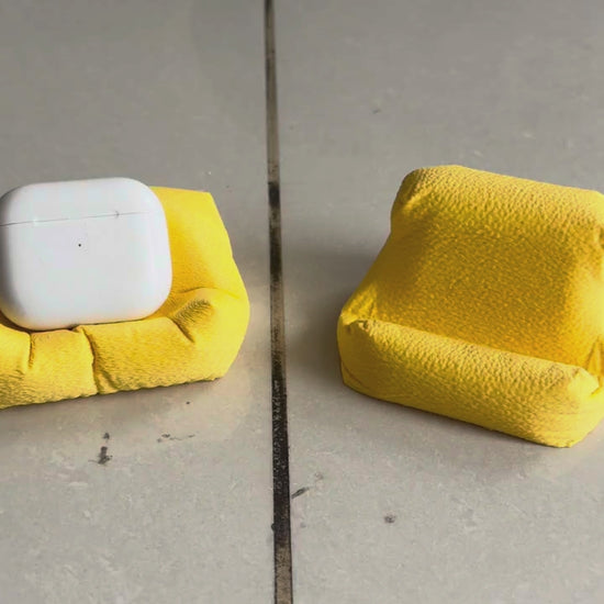 Cushion Bean AirPod Stand — holding an AirPods case