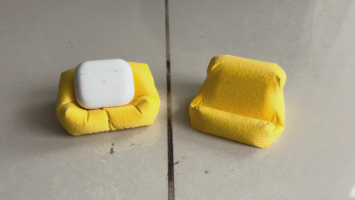 Cushion Bean AirPod Stand — holding an AirPods case