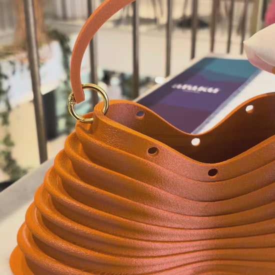 Thorax Bag detail — ribbed structure, holes and gold handle ring