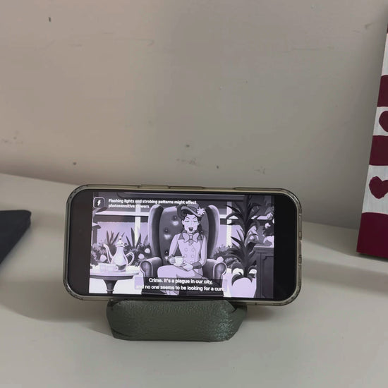 Cushion Bean Pod holding a phone playing a video
