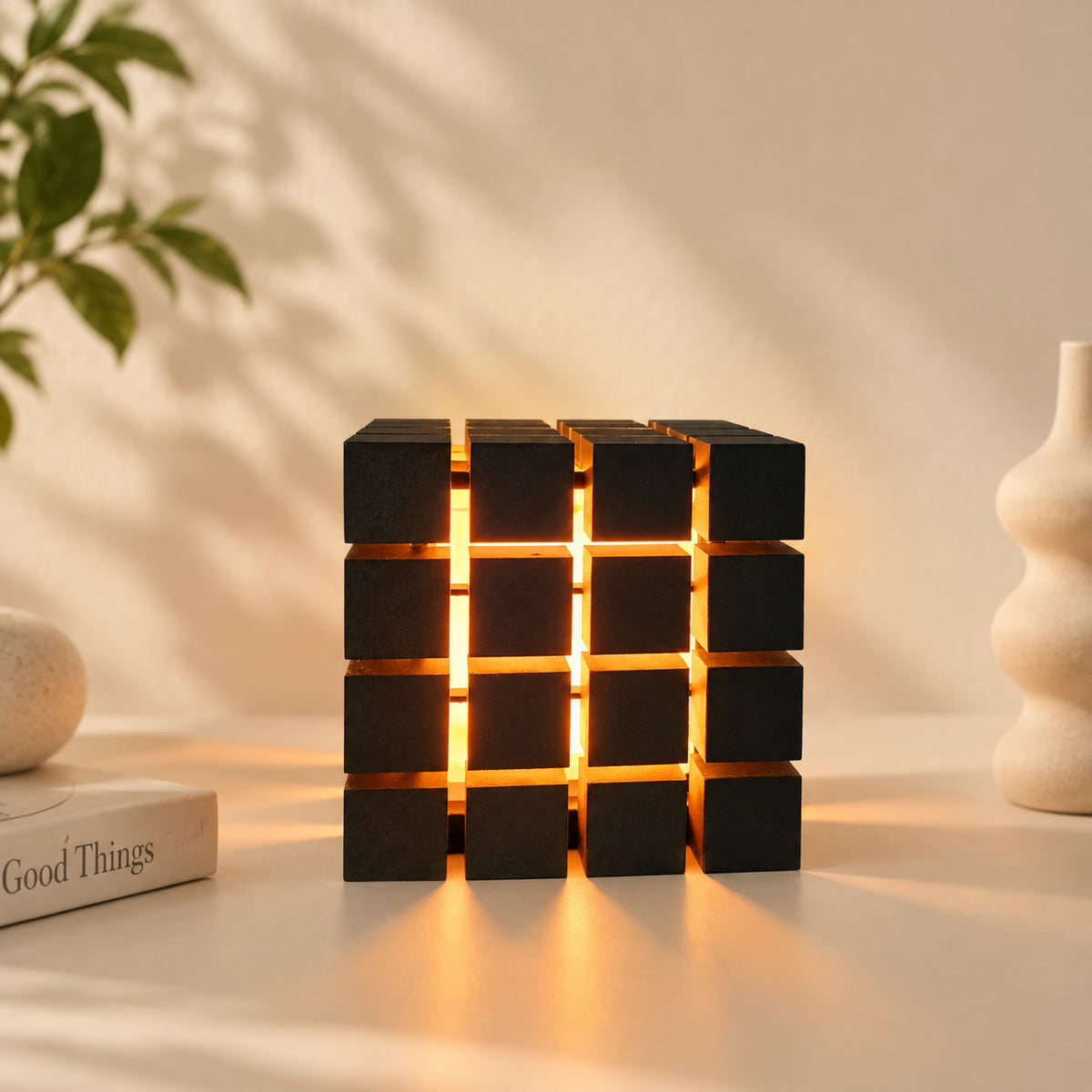 Rubrik Lamp — styled on a shelf with soft warm glow