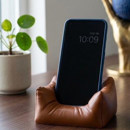 Sofa Lounger Phone Stand in chocolate brown holding a phone