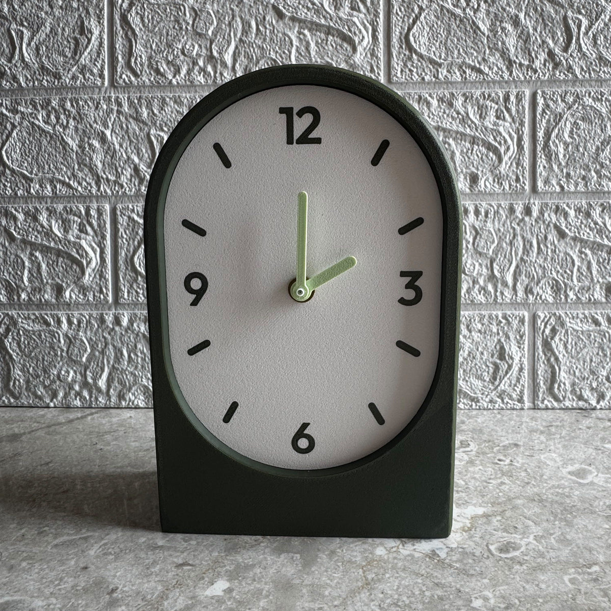 Solace clock in olive, vertical arch on a shelf
