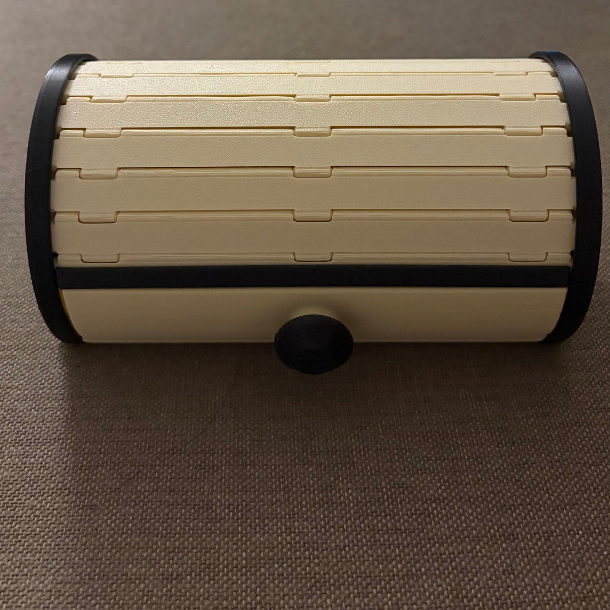 Tambour Vault Storage Box on a sofa